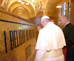 Pope Francis blessing a piece of the Trinity Dome Mosaic