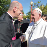 Monsignor Rossi welcomes Pope Francis.