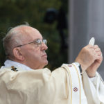 Pope Francis elevates the Sacred Host.